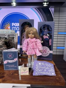 Faith Friends Co. 18-inch dolls on a TV set