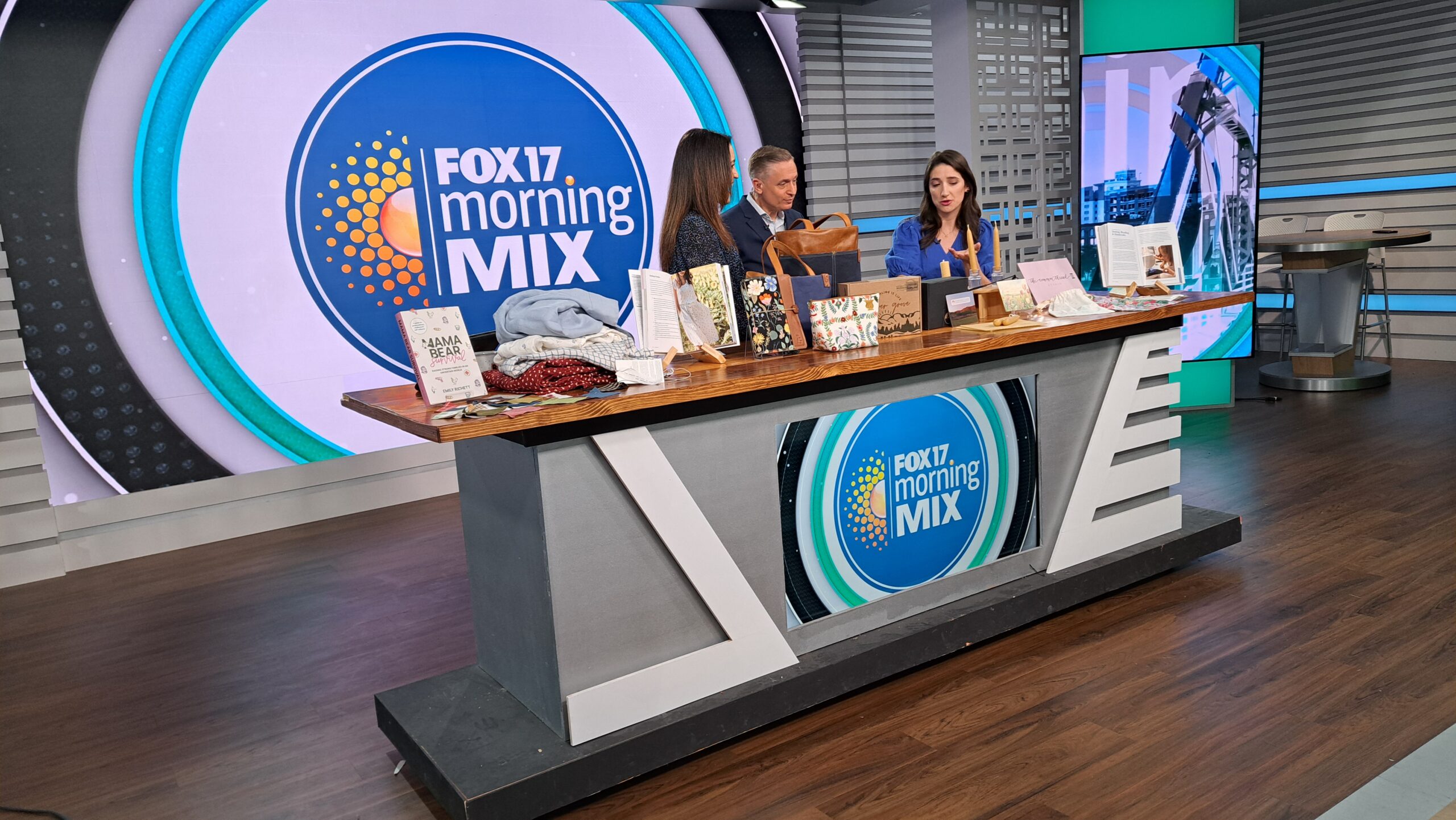 Hosts of FOX 17 Morning Mix posing with products